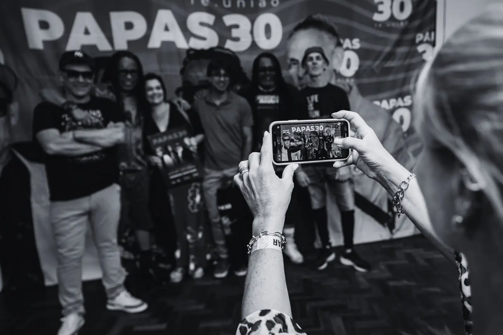 Fã fotografando a banda com o celular